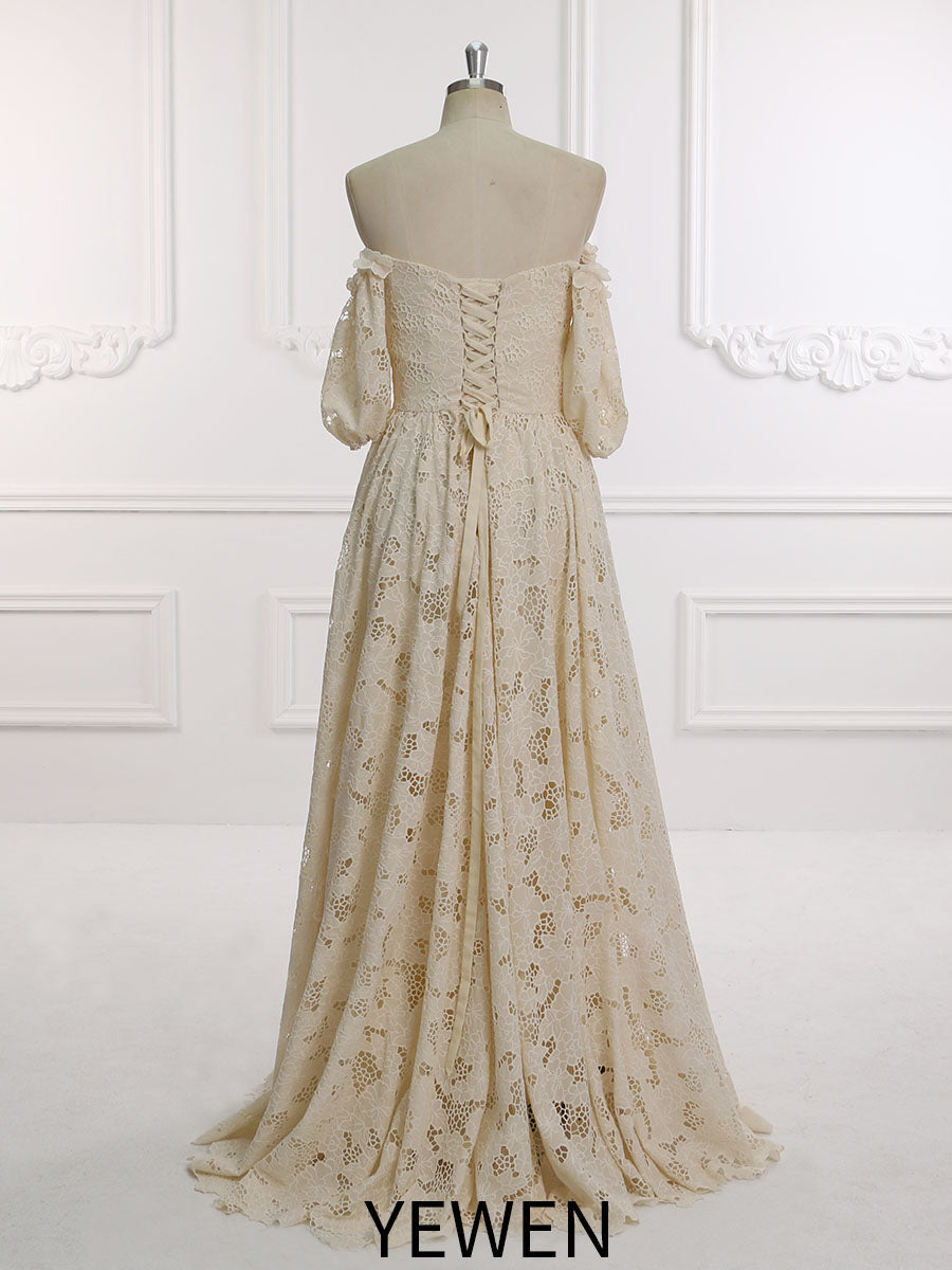 Back view of an elegant ivory half sleeve off shoulder lace wedding dress displayed on a mannequin.
