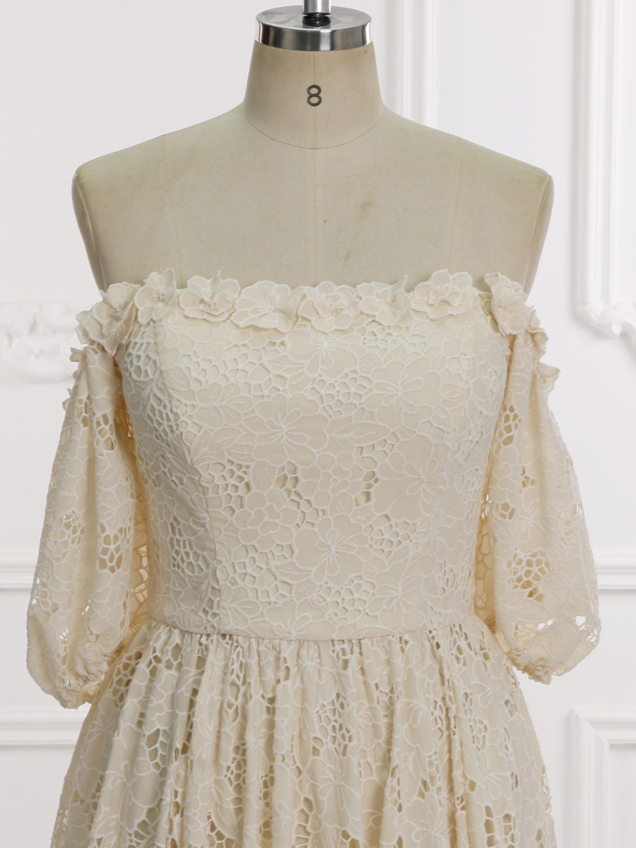Close-up front view of an elegant ivory lace wedding dress highlighting the off shoulder neckline and half sleeves on a mannequin.