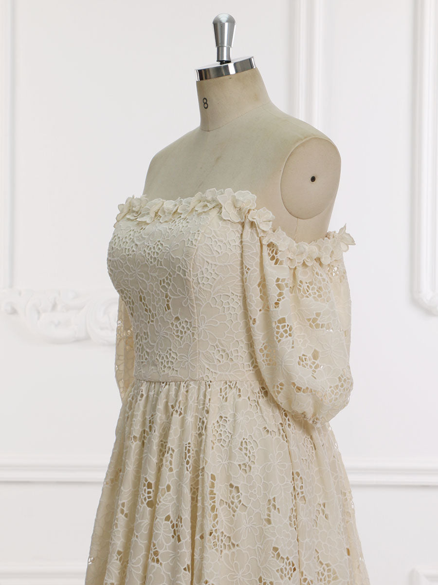 Close-up side view of an elegant ivory lace wedding dress highlighting the half sleeve and off shoulder design on a mannequin.