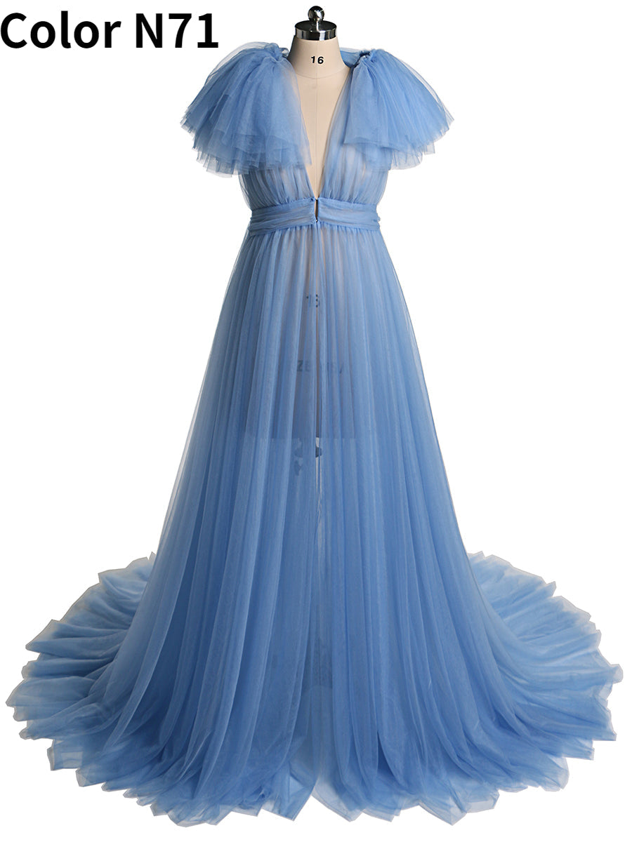 Front view of light blue maternity dress for photo shoot featuring tulle flowers and elegant flowing maxi design