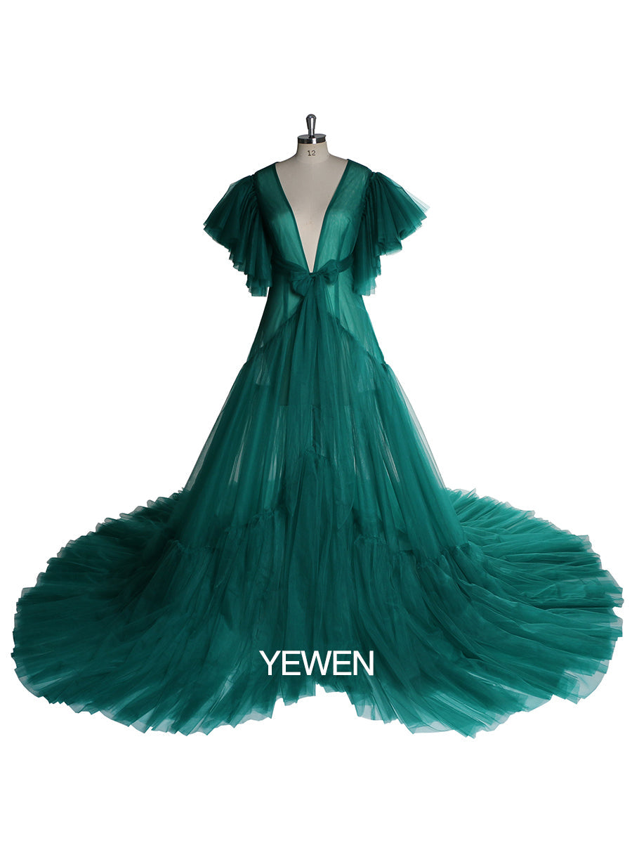 Front view of green maternity dress for photo shoot featuring V-neck design, bow detail, and short sleeves