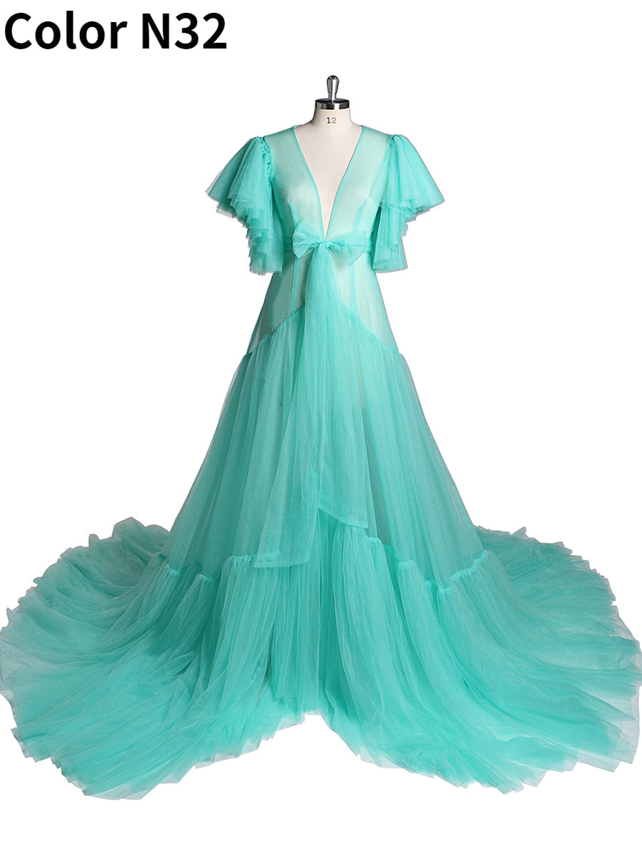 Front view of ocean maternity dress for photo shoot featuring V-neck design, bow detail, and short sleeves