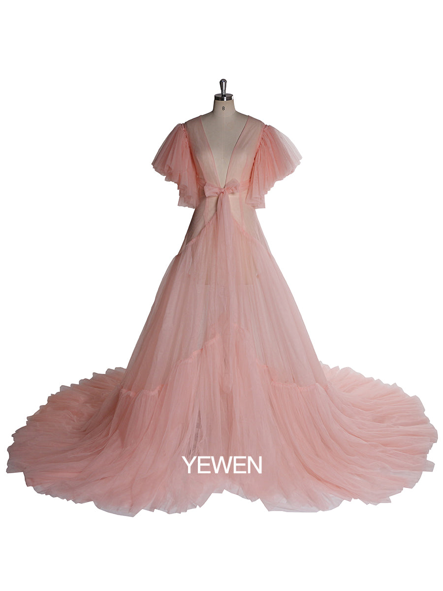 Front view of pink maternity dress for photo shoot featuring V-neck design, bow detail, and short sleeves