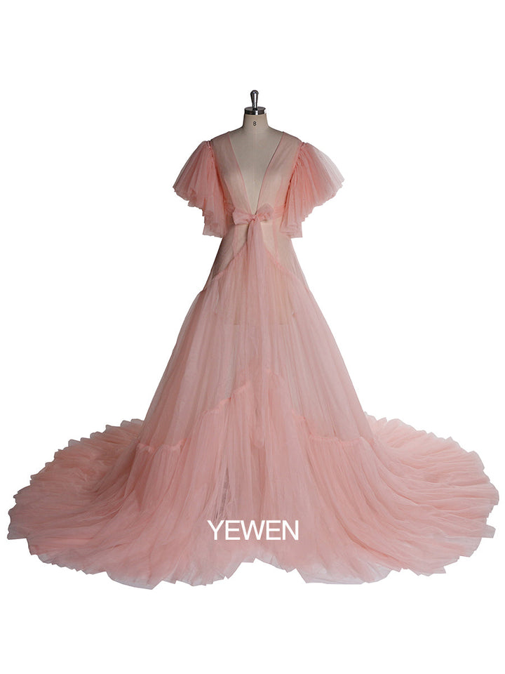 Front view of pink maternity dress for photo shoot featuring V-neck design, bow detail, and short sleeves