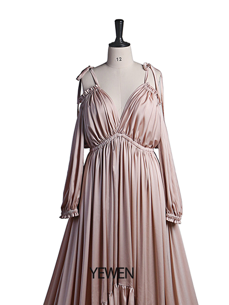 Close-up of elegant fabric detail on shoulderless maternity photoshoot dress showing soft flowing texture