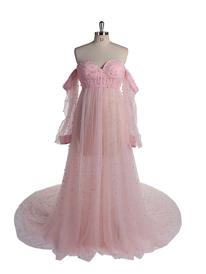 Front view of pink maternity photoshoot gown with open front design and elegant pearl detailing