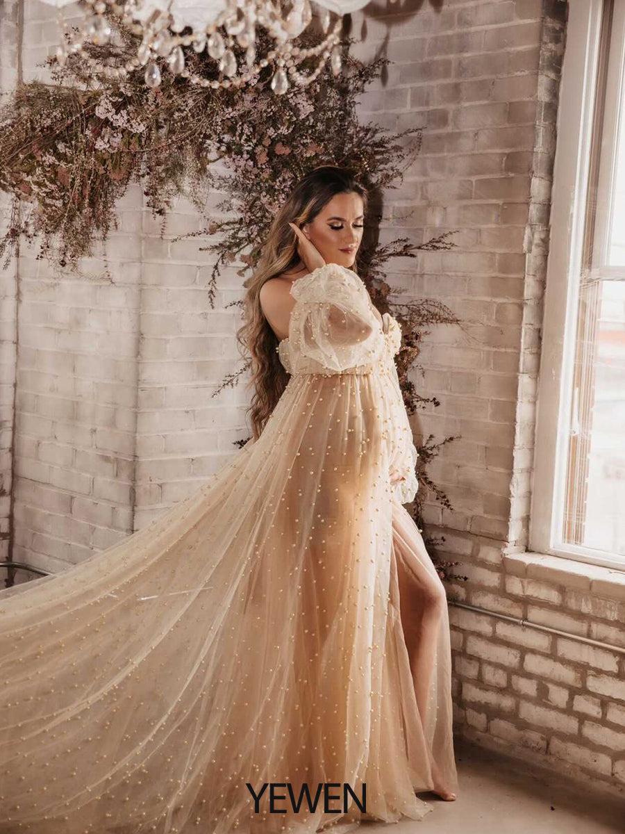Full body view of ivory off shoulder maternity photoshoot gown with pearl details for elegant photography