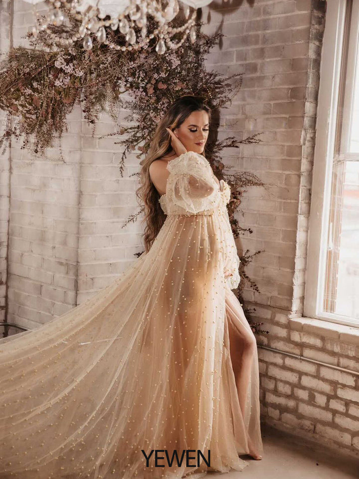 Full body view of ivory off shoulder maternity photoshoot gown with pearl details for elegant photography