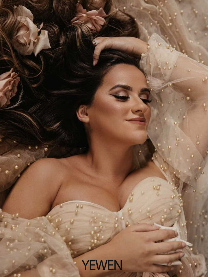 Close-up of handmade pearl embellishments on ivory maternity photoshoot gown