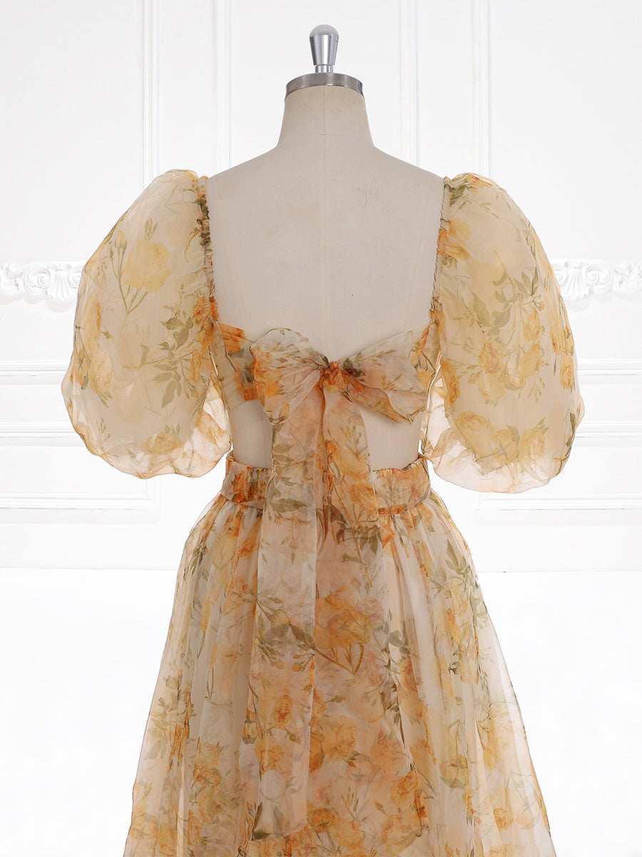 Close-up back detail of photoshoot dress highlighting balloon sleeves and romantic floral details