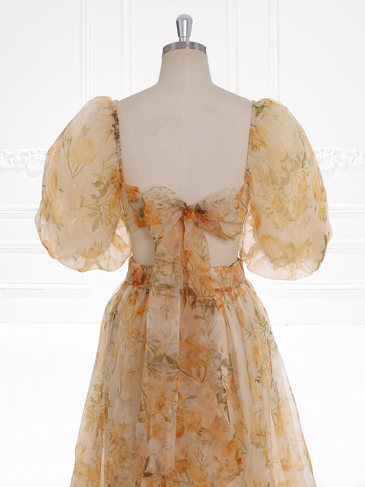 Close-up back detail of photoshoot dress highlighting balloon sleeves and romantic floral details