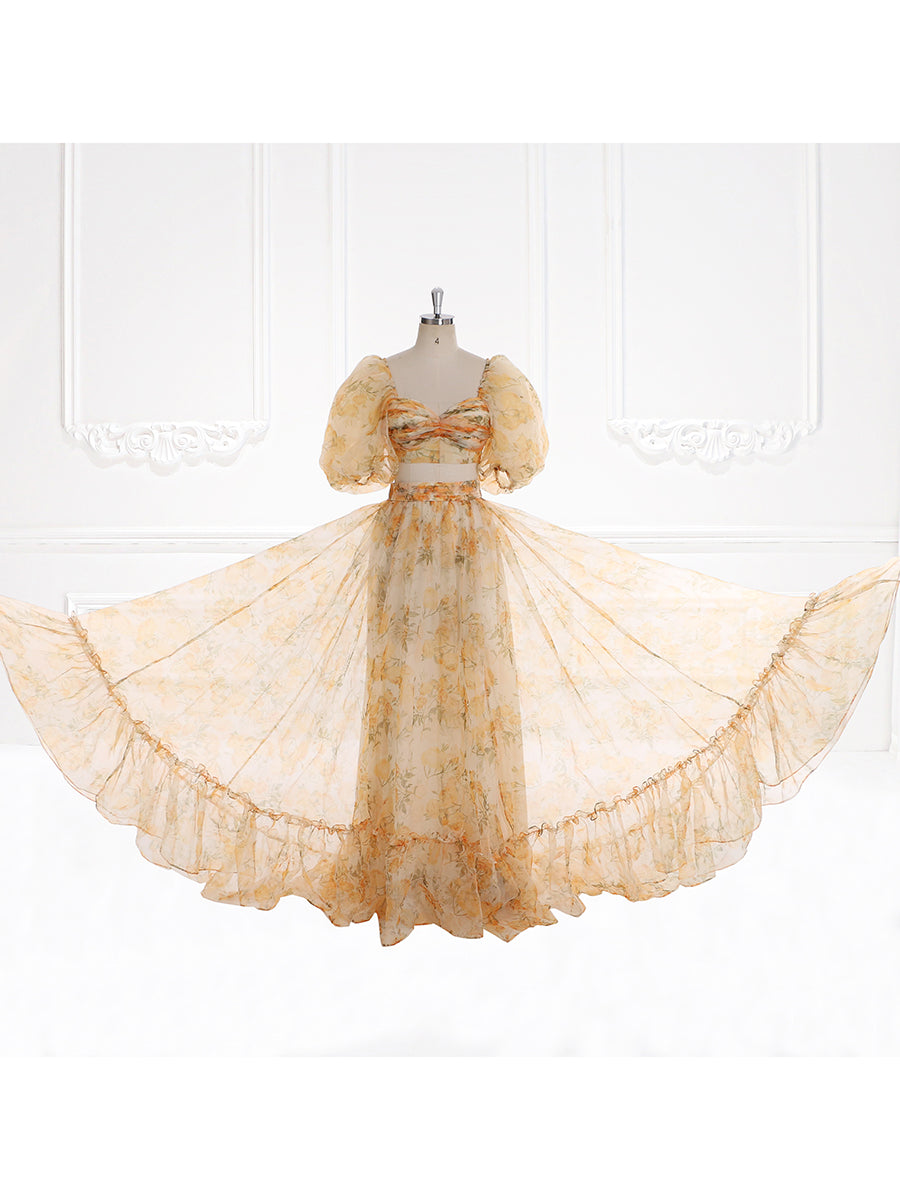 Full body view of photoshoot dress featuring A-line floral gown with balloon sleeves