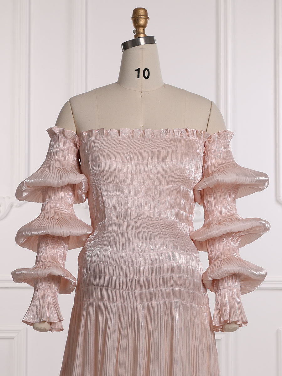 Close-up front detail of pleated maternity dress showing delicate pleated texture and fabric craftsmanship