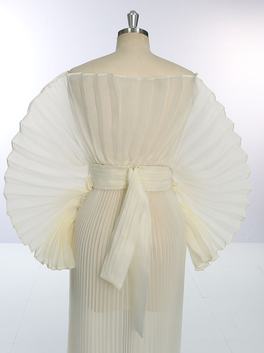 Close-up of delicate pleated organza fabric on maternity photoshoot dress showing fine craftsmanship