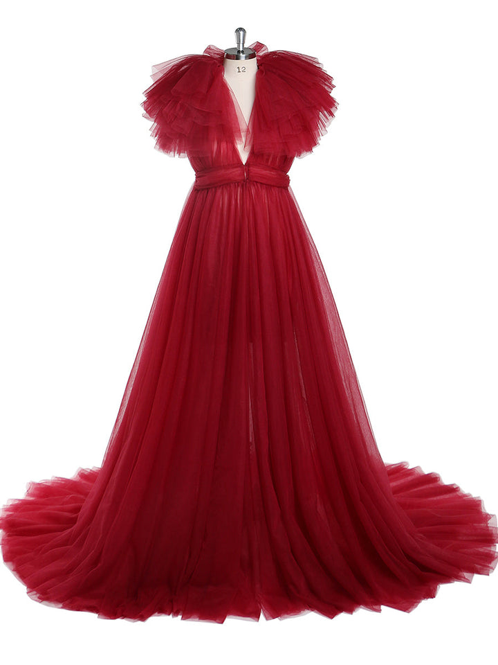 Front view of red maternity dress for photo shoot featuring tulle flowers and elegant flowing maxi design