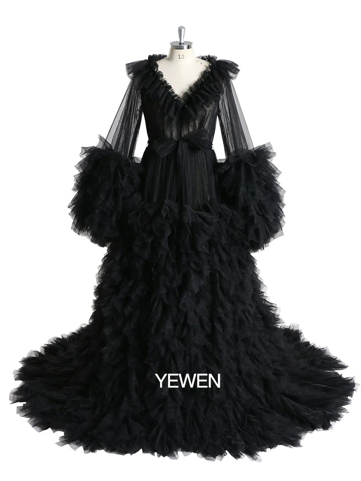 Front view of ruffled maternity dress for photo shoot featuring black color, V-neck design, and elegant silhouette
