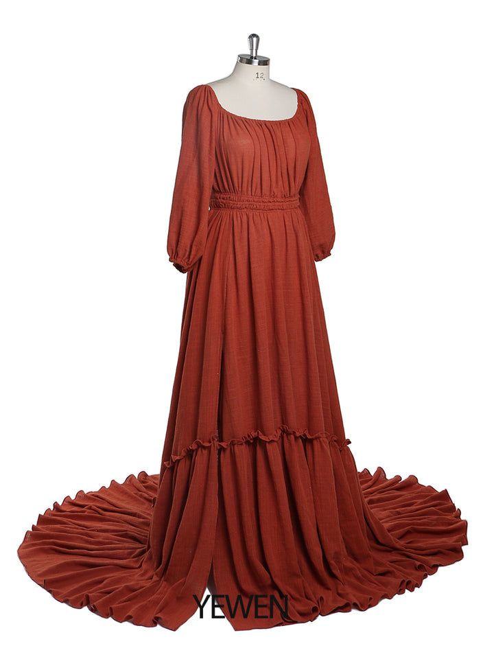 Side view of rust boho maternity photoshoot dress showing full sleeves and flowing bohemian silhouette