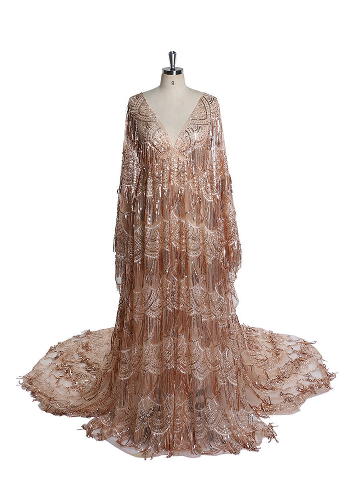 A maternity dress featuring a deep V-neck, long sleeves, and a side slit with a sequin and tulle fabric.