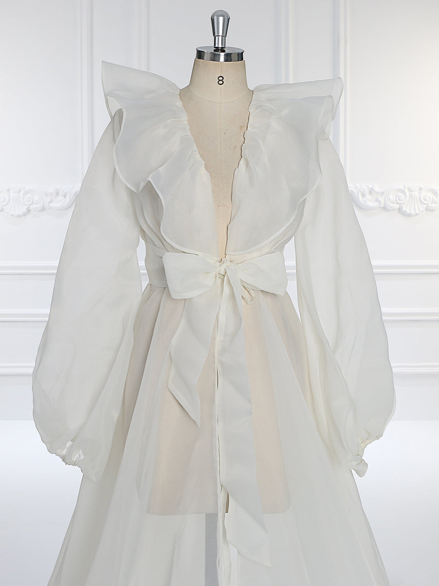 Close-up of puffy sleeve detail on silk organza maternity dress showing soft airy texture and craftsmanship