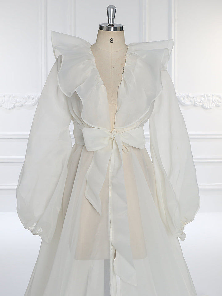 Close-up of puffy sleeve detail on silk organza maternity dress showing soft airy texture and craftsmanship