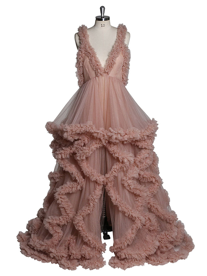 Front view of pink sleeveless maternity dress for photoshoot featuring elegant ruffle design and flowing silhouette