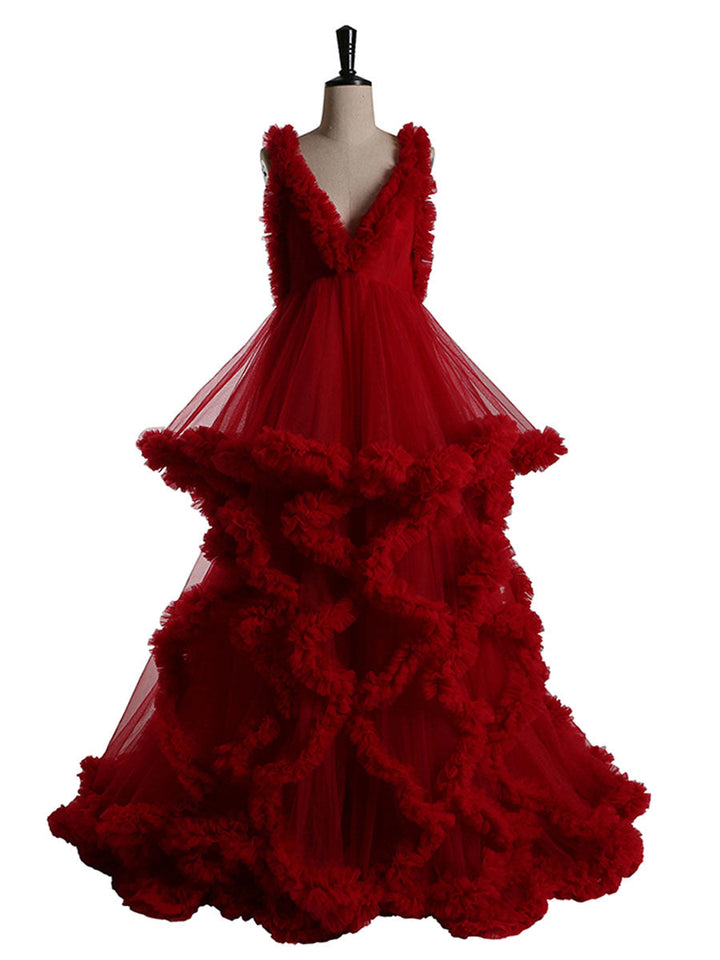 Front view of red sleeveless maternity dress for photoshoot featuring elegant ruffle design and flowing silhouette