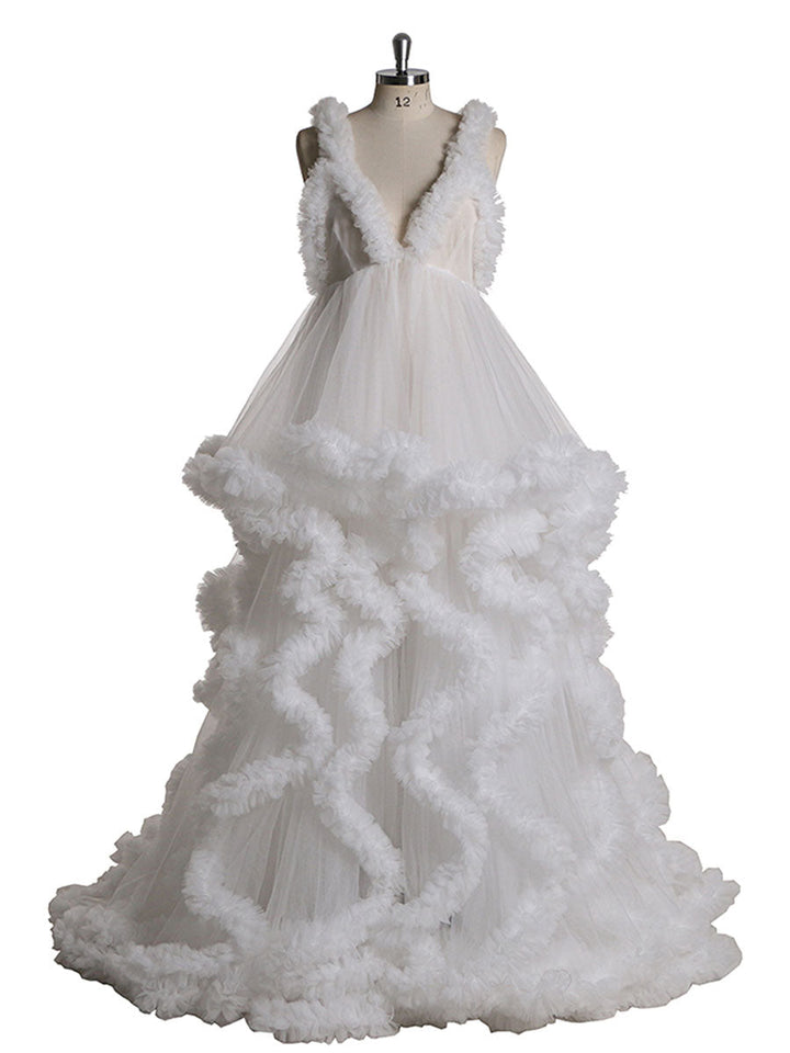 Front view of white sleeveless maternity dress for photoshoot featuring elegant ruffle design and flowing silhouette