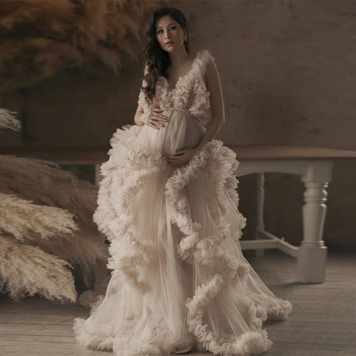 Full body view of sleeveless maternity dress for photoshoot with elegant ruffle design and flowing silhouette