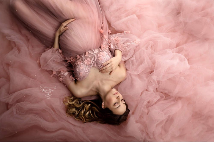 Romantic tulle maternity photoshoot dress styled in soft light for pregnancy and wedding photography