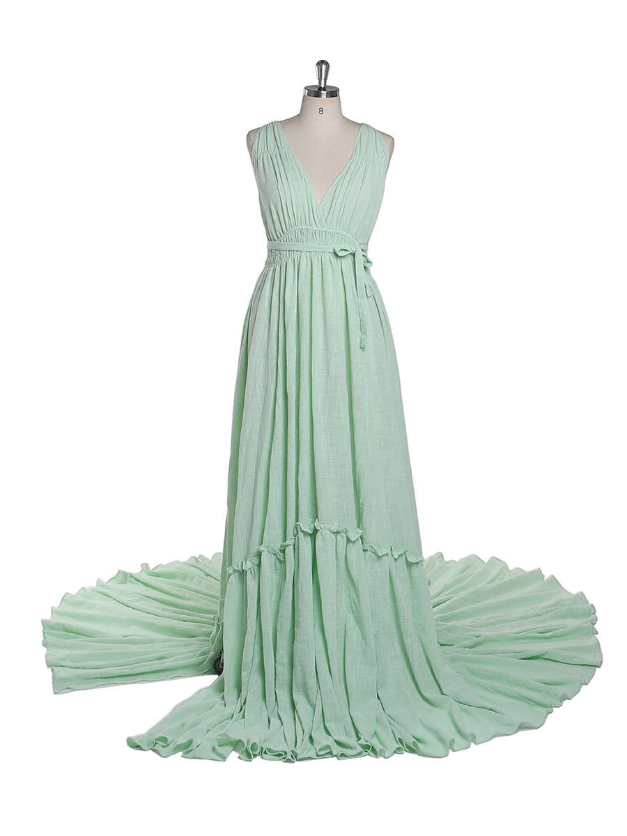 Front view of green V neck photography dress featuring stretch waist design and elegant maternity evening gown silhouette