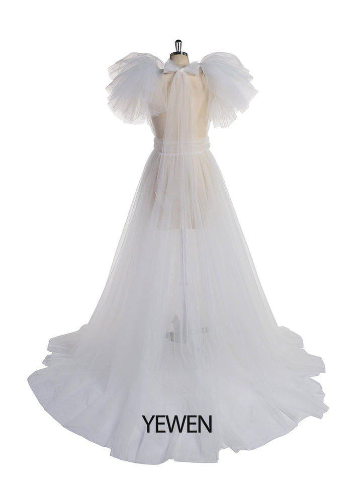 Back view of white maternity dress for photo shoot with elegant tulle flowers and long flowing silhouette