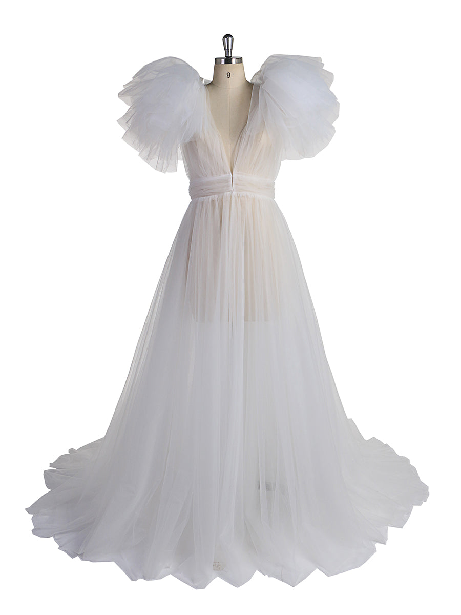 Front view of white maternity dress for photo shoot featuring tulle flowers and elegant flowing maxi design