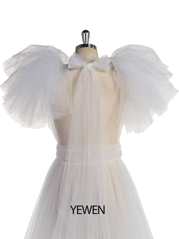 Close-up of tulle flower detailing on white maternity dress for photo shoot showing soft handcrafted texture